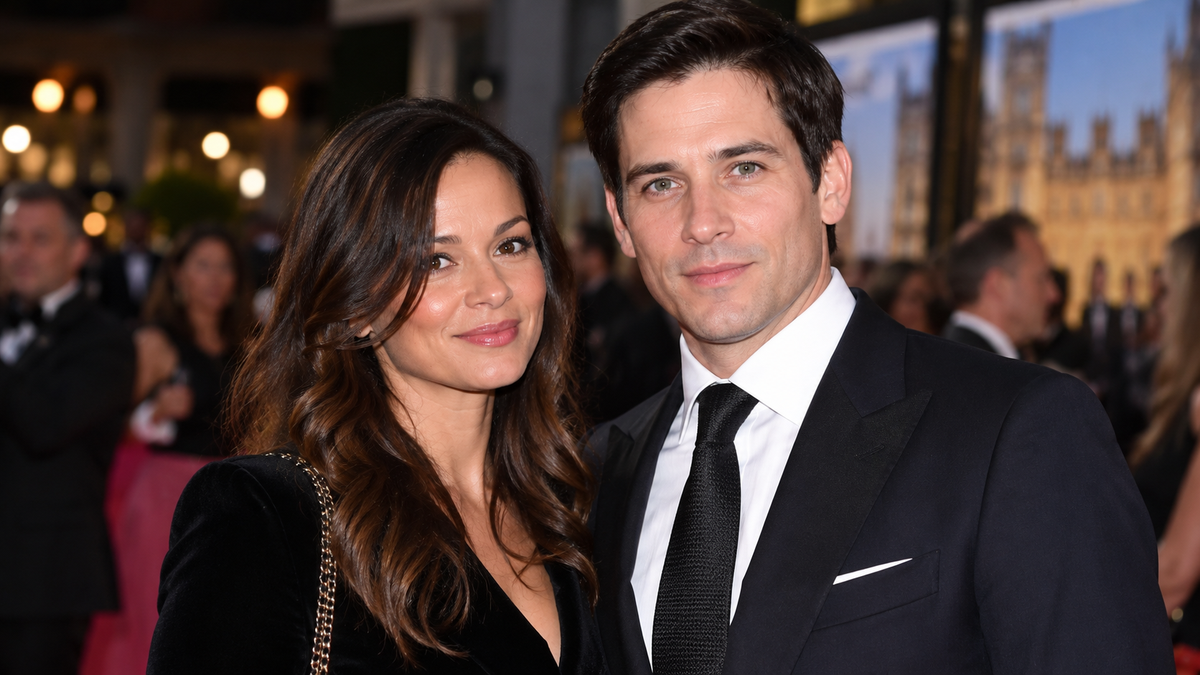 Lauren Chandiram and Rob James-Collier posing together at a formal event.
