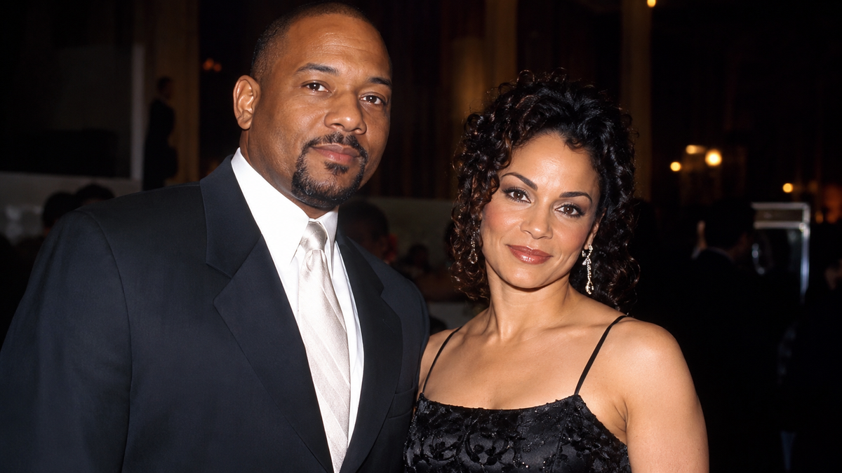 A formally dressed man and woman posing together at an evening event.